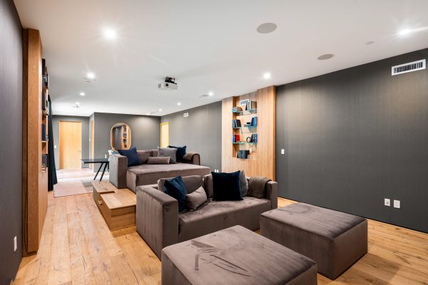 A stylish and cozy home theater with elegant decor and wooden accents